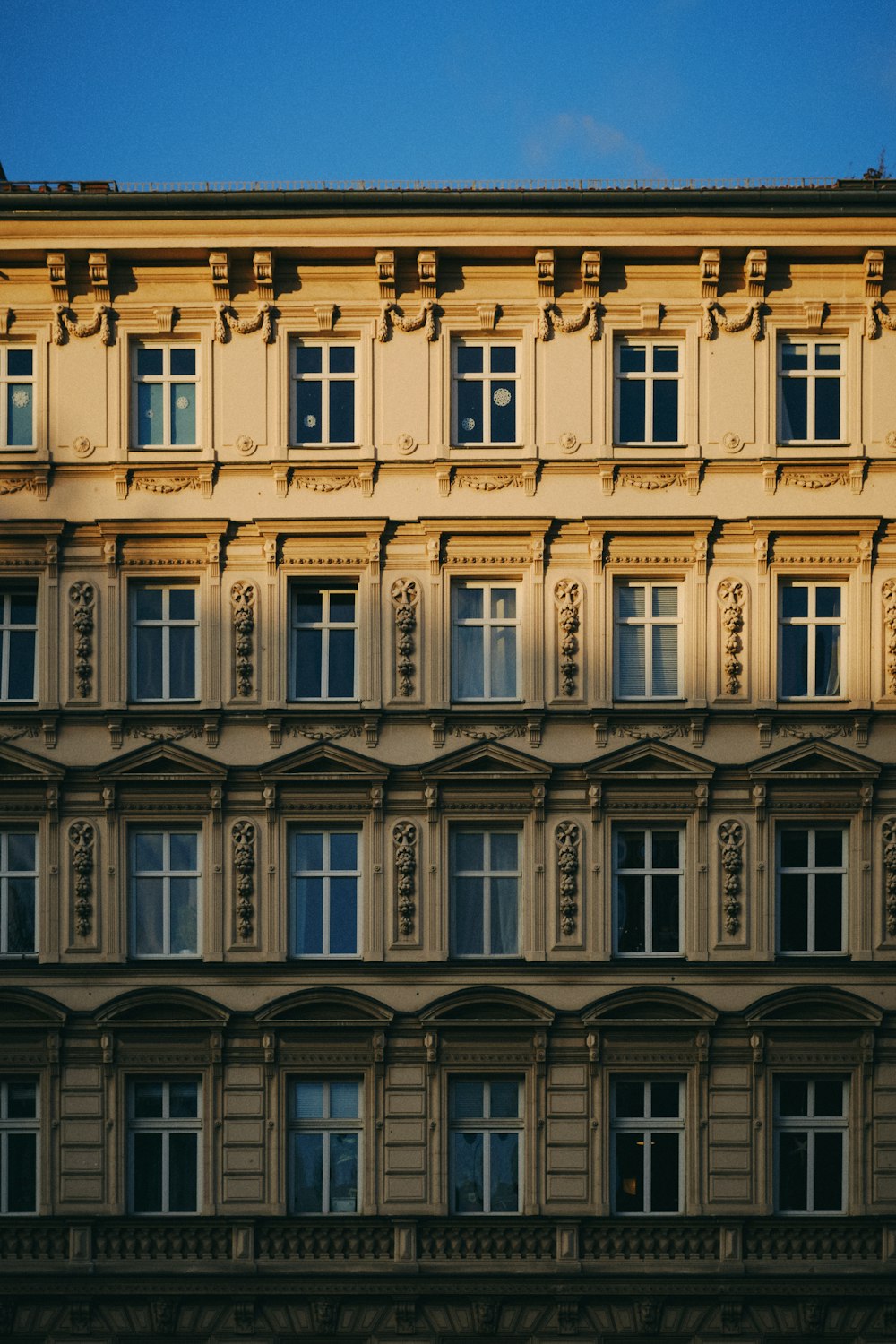 a building with many windows and a clock on the front of it