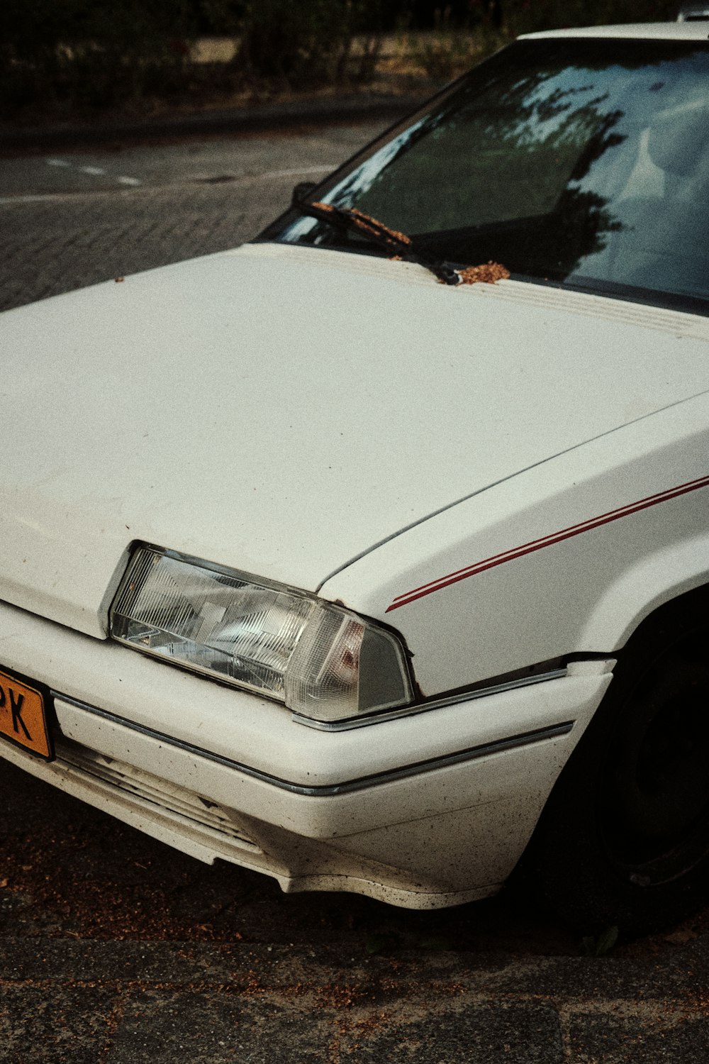 a white car parked on the side of the road