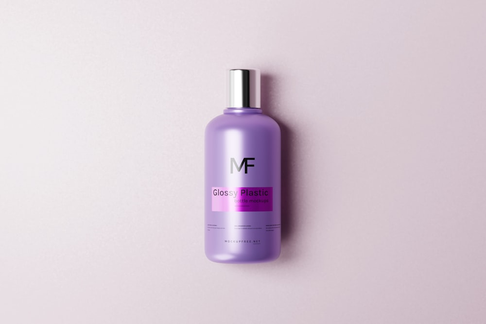 a bottle of hair product on a pink background