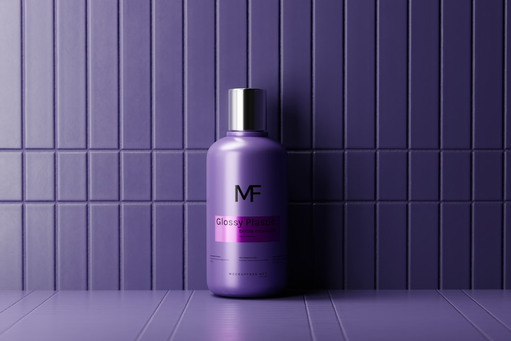 a purple bottle of shampoo sitting on a tiled floor