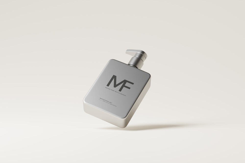 a bottle of cologne sitting on top of a white surface