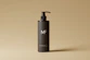 a bottle of mf shampoo on a tan background
