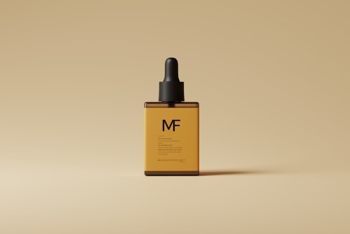 A close-up of a small amber dropper bottle labeled 'mounjax' set against a wooden table background.