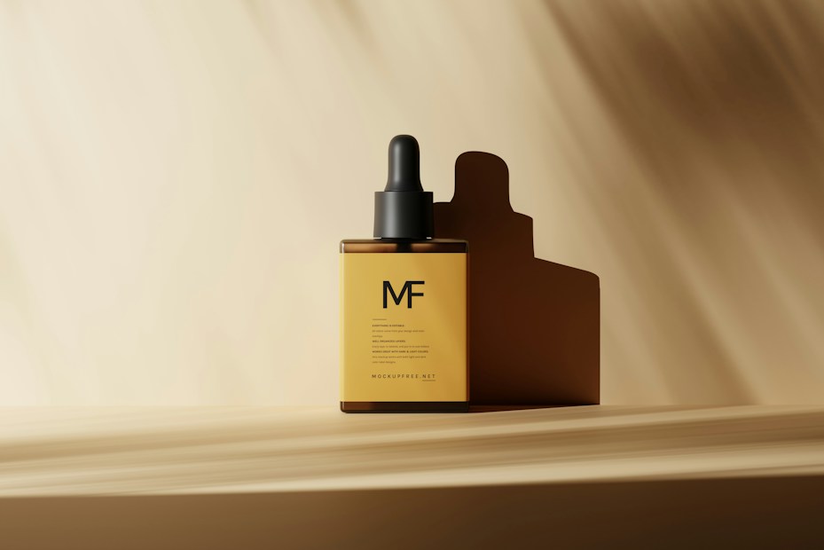 A sleek amber dropper bottle with a black cap is placed on a light brown surface. Soft shadows create a serene ambiance, and the lighting highlights the minimalistic design. The background is a gradient of light beige, complementing the overall aesthetic.