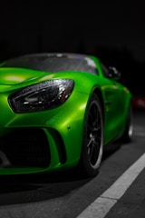 A sleek vehicle gleaming after a detailed wash, highlighted by neon green reflections.
