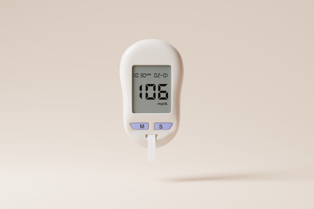 a digital thermometer on a beige background