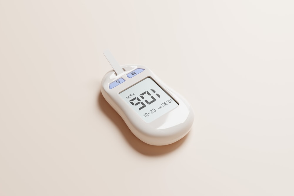 a digital thermometer on a beige background