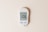 A digital glucose meter displaying a blood sugar reading of 106 mg/dL, with a date and time shown as 10:30 am on 02-01. The device features two buttons labeled 'M' and 'S' and is designed in a sleek, modern style on a plain, light background.