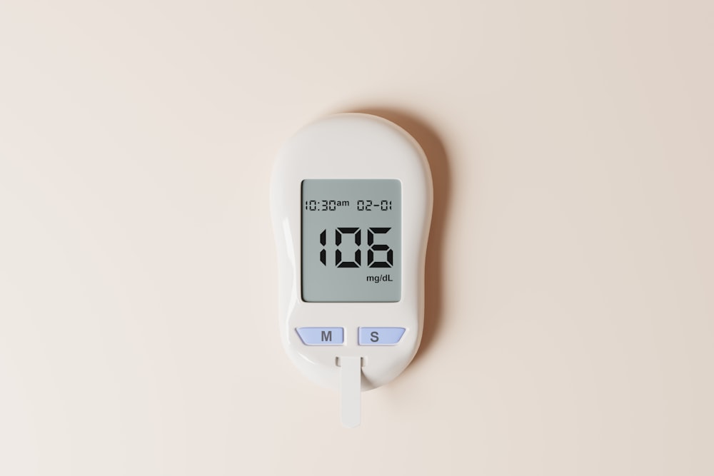 a digital thermometer on a white wall
