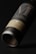 A close-up view of a wine bottle with a minimalist and elegant design. The label features large, stylized letters and subtle text beneath. The bottle is tilted on its side against a dark background, emphasizing the sleek and polished appearance.