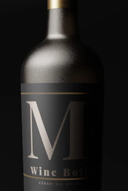 Close-up of q’lyme vodka’s intricate label design showing the fine gold embossing on luxurious black glass.