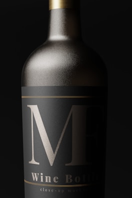 A close-up view of an elegantly designed wine bottle with a matte black label and bold silver markings. The bottle appears metallic, with a sleek, sophisticated look.