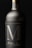 A close-up view of an elegantly designed wine bottle with a matte black label and bold silver markings. The bottle appears metallic, with a sleek, sophisticated look.