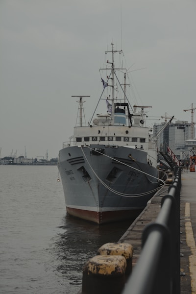 a large boat is docked at a pier