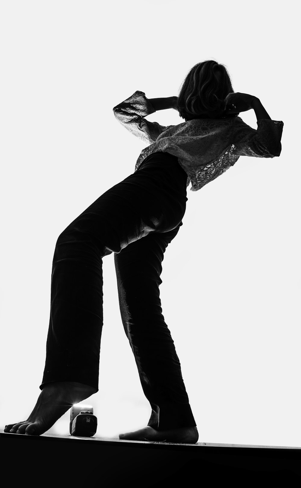 a black and white photo of a woman on a skateboard