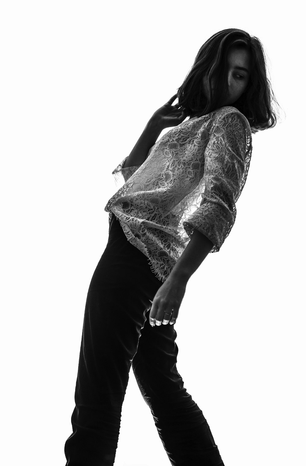 a black and white photo of a woman skateboarding