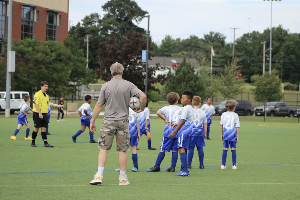 a group of young men standing on top of a soccer field