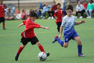 a group of young boys playing a game of soccer
