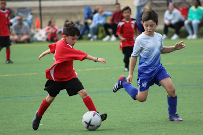 a group of young boys playing a game of soccer
