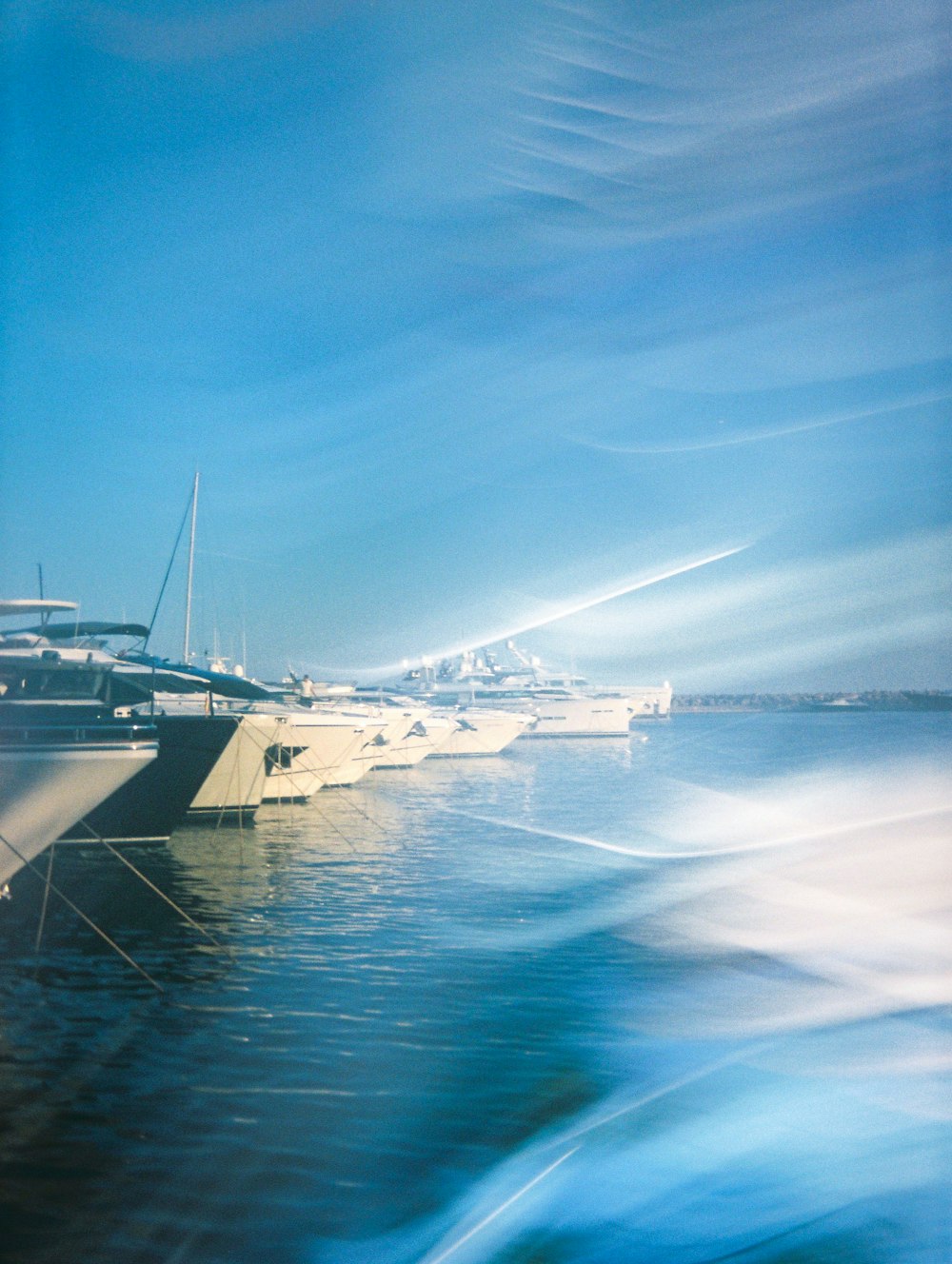 a group of boats floating on top of a body of water