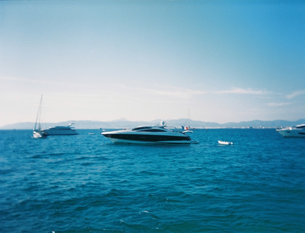 a group of boats floating on top of a large body of water