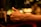 A close-up of a person giving a thumbs up with a laptop.