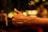 A close-up of a person giving a thumbs-up in a creative workspace.