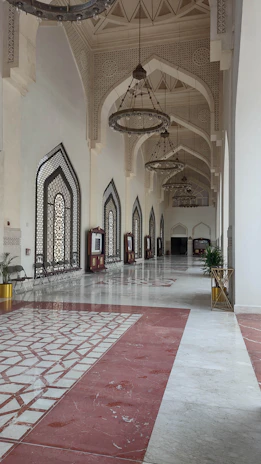 Restored palace hallway featuring traditional Omani wooden ceilings and colorful tile patterns.