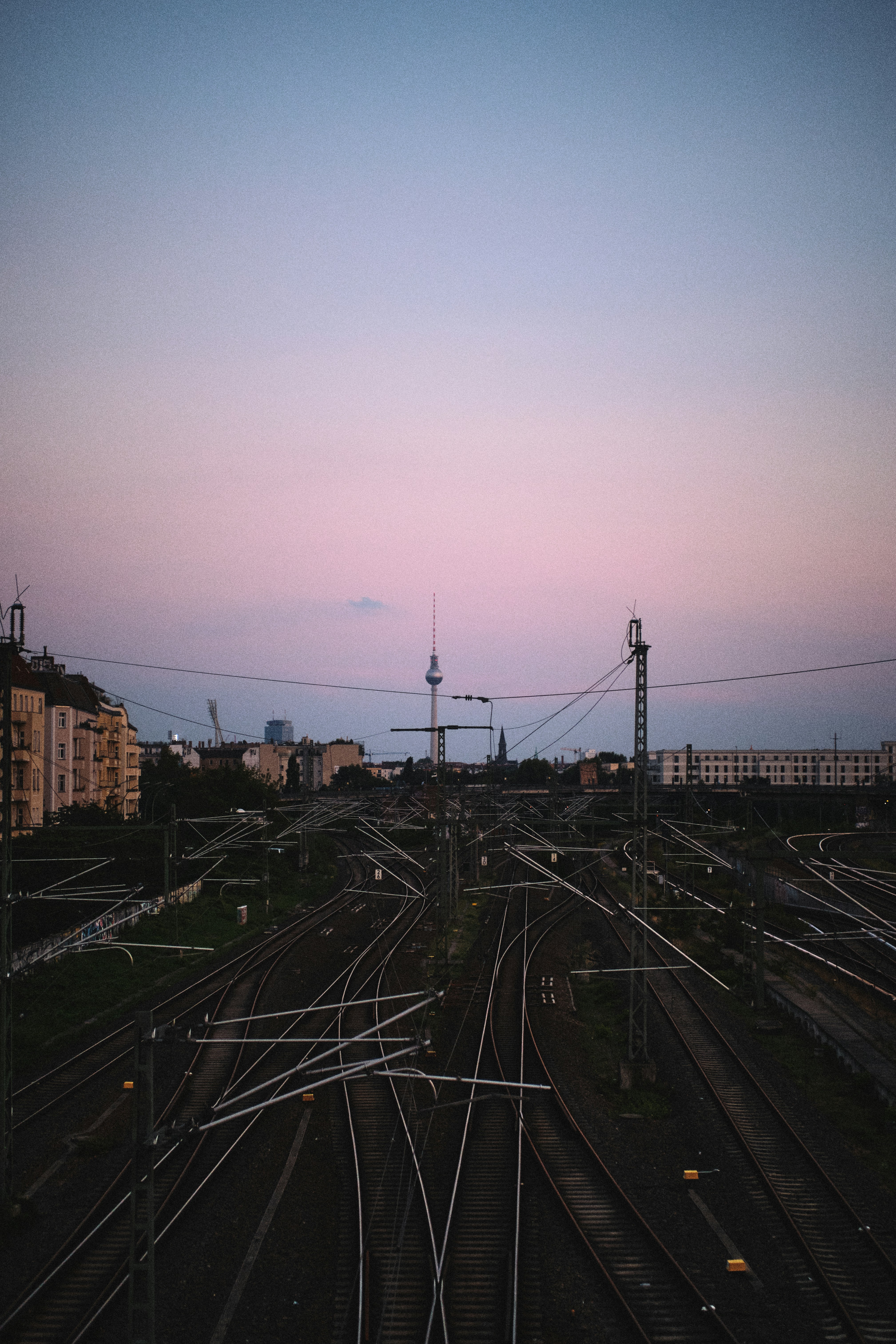 a view of a train yard at dusk