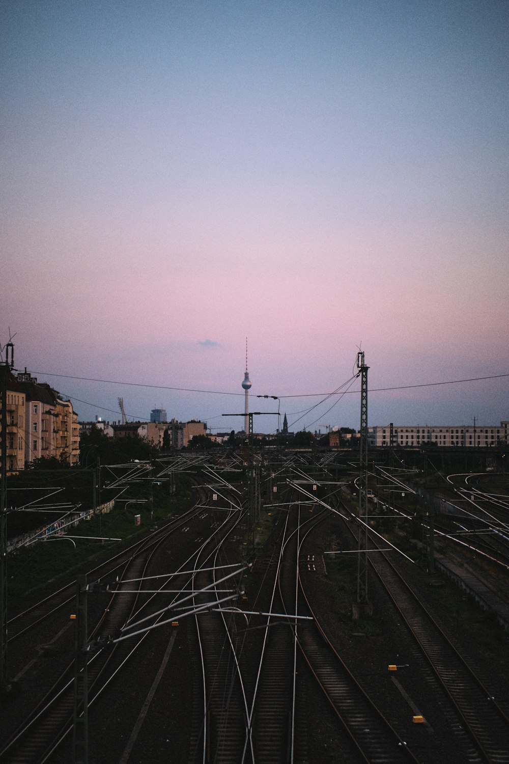 a view of a train yard at dusk