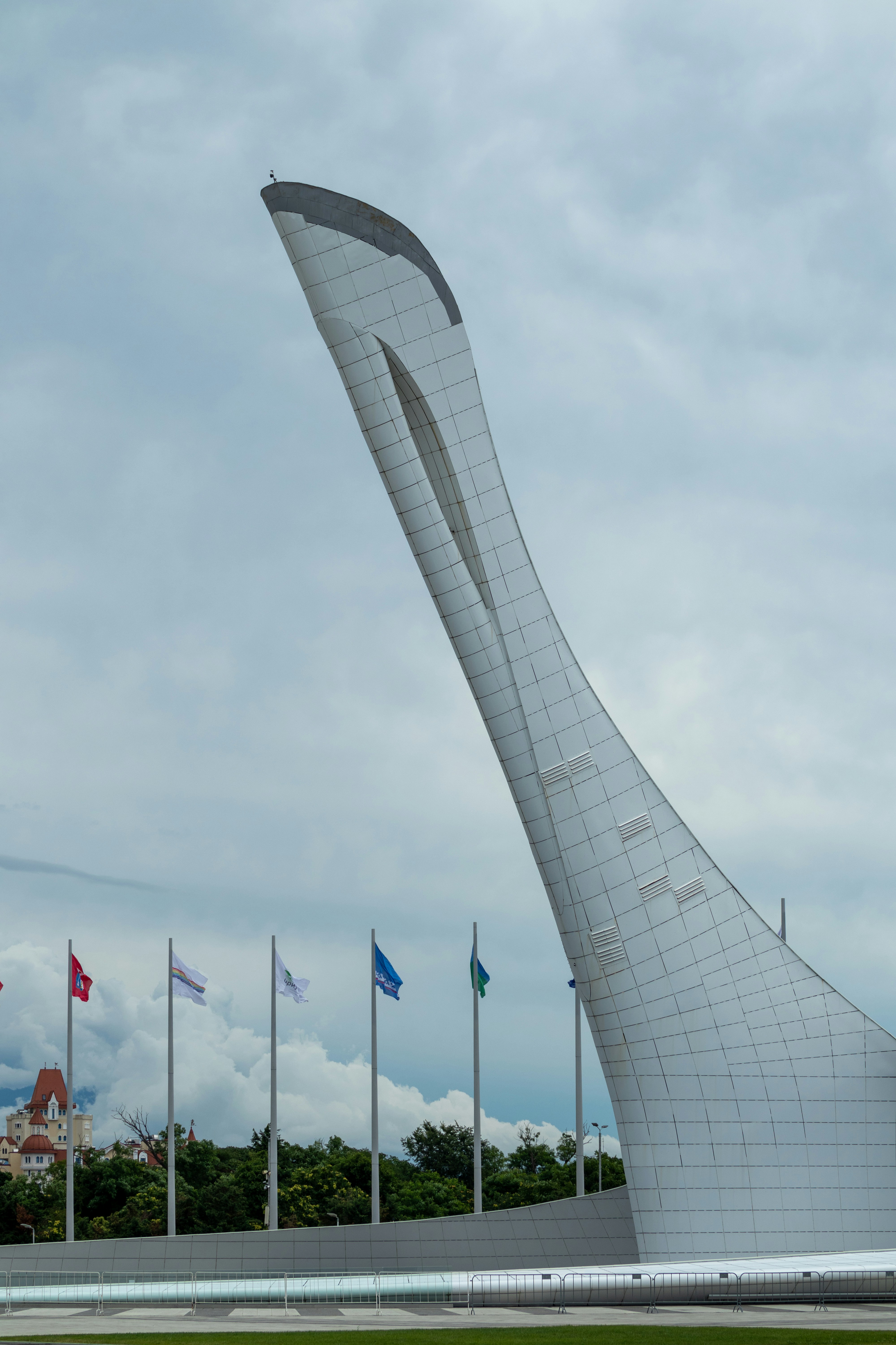 a tall white building with a curved design