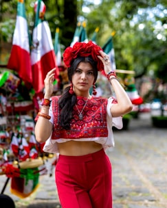 a woman in a red skirt and a white top