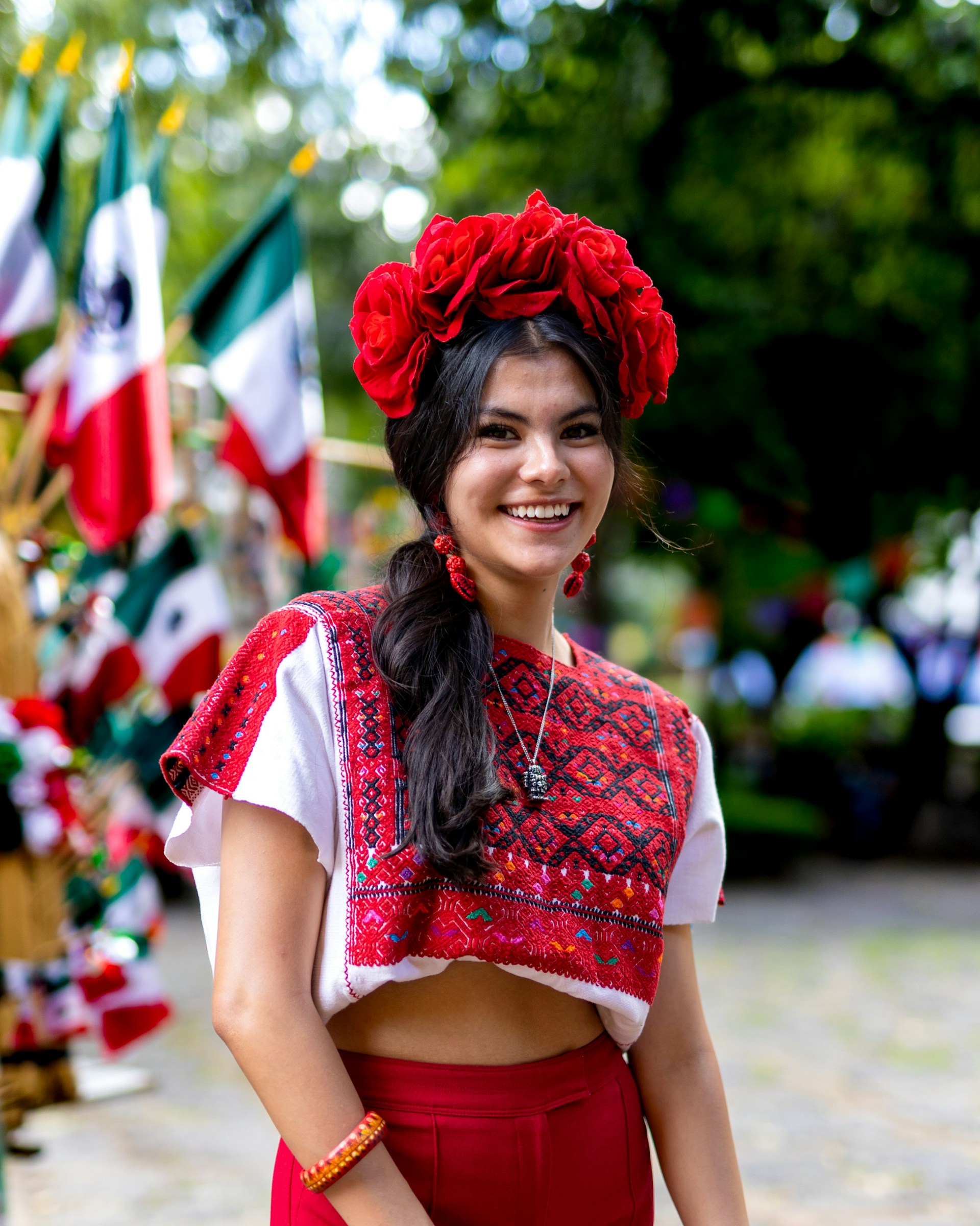a woman wearing a red skirt and a red flower in her hair