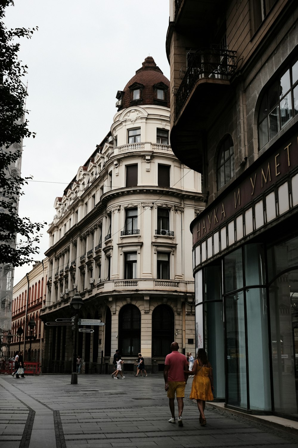 a couple of people that are walking down a street