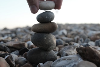 a person stacking rocks on top of each other