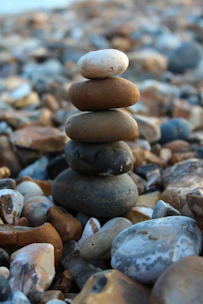 a pile of rocks sitting on top of a beach