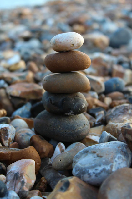 a pile of rocks sitting on top of a beach