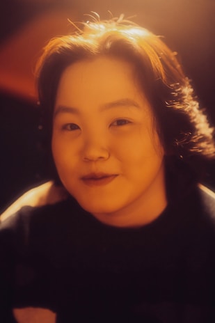 Bador engaging warmly with fans at a film festival, bathed in elegant ambient lighting with gold tones.