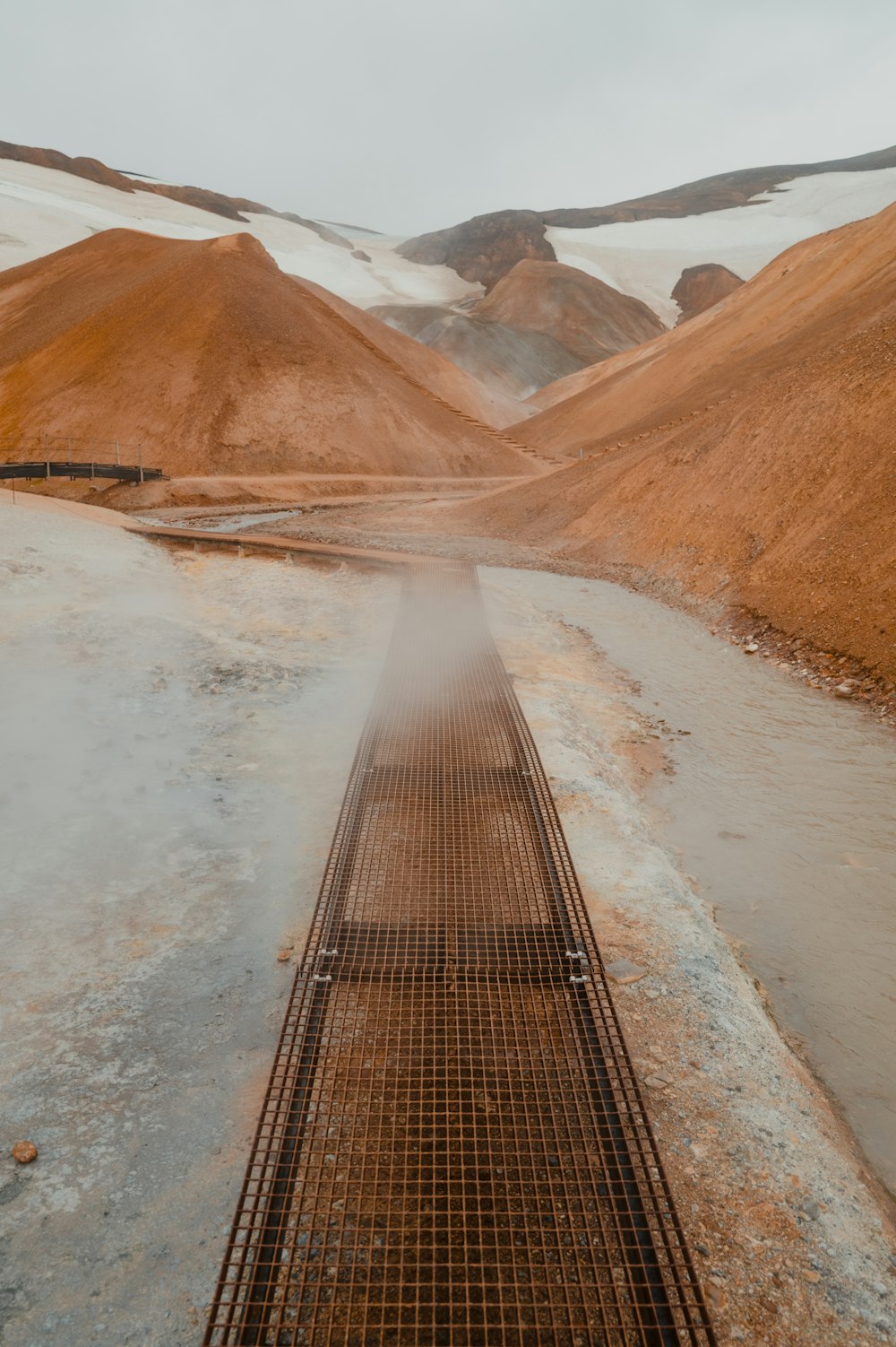 a train traveling through a valley covered in snow