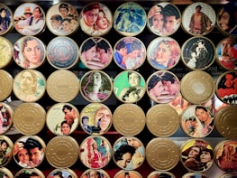 A nostalgic collage of iconic classic movie stars smiling and posing on set.