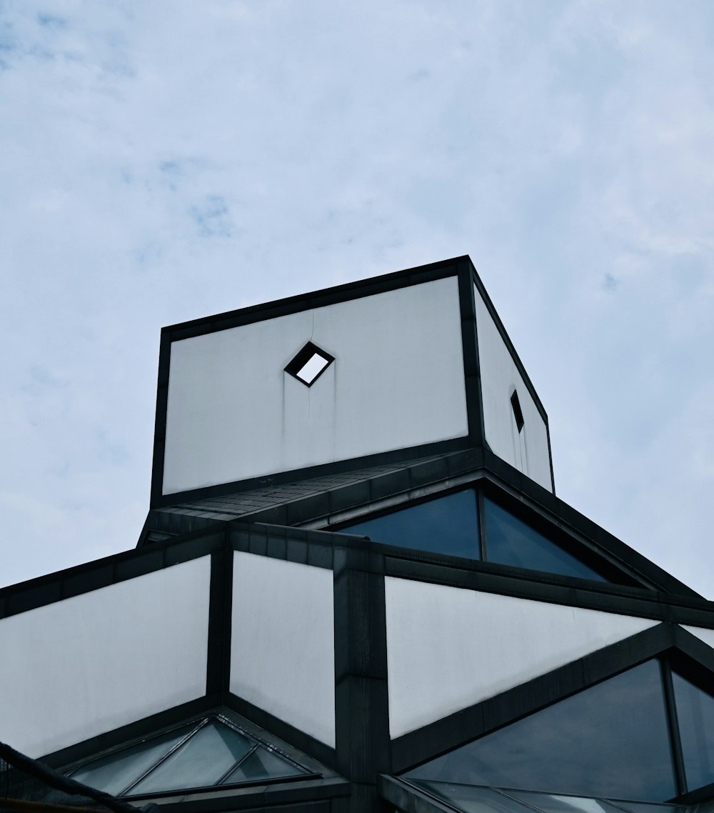 a black and white building with a sky background