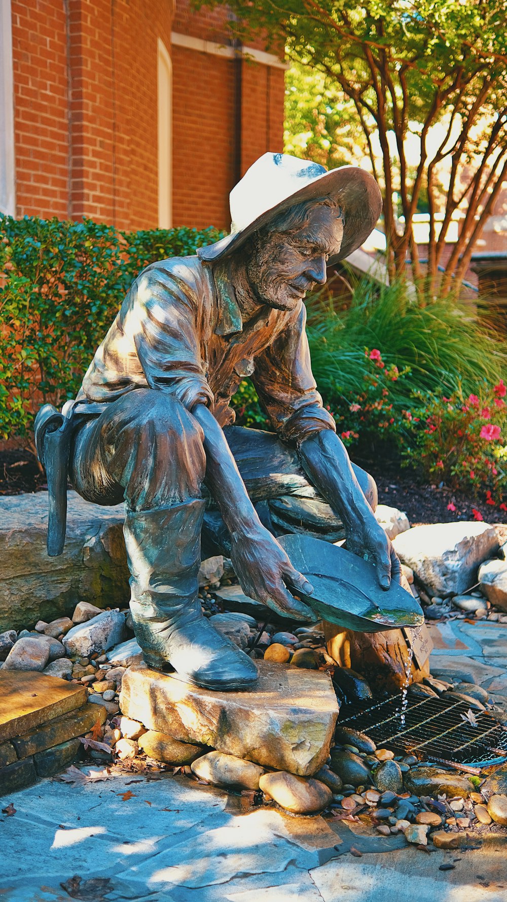 a statue of a man sitting on top of a rock