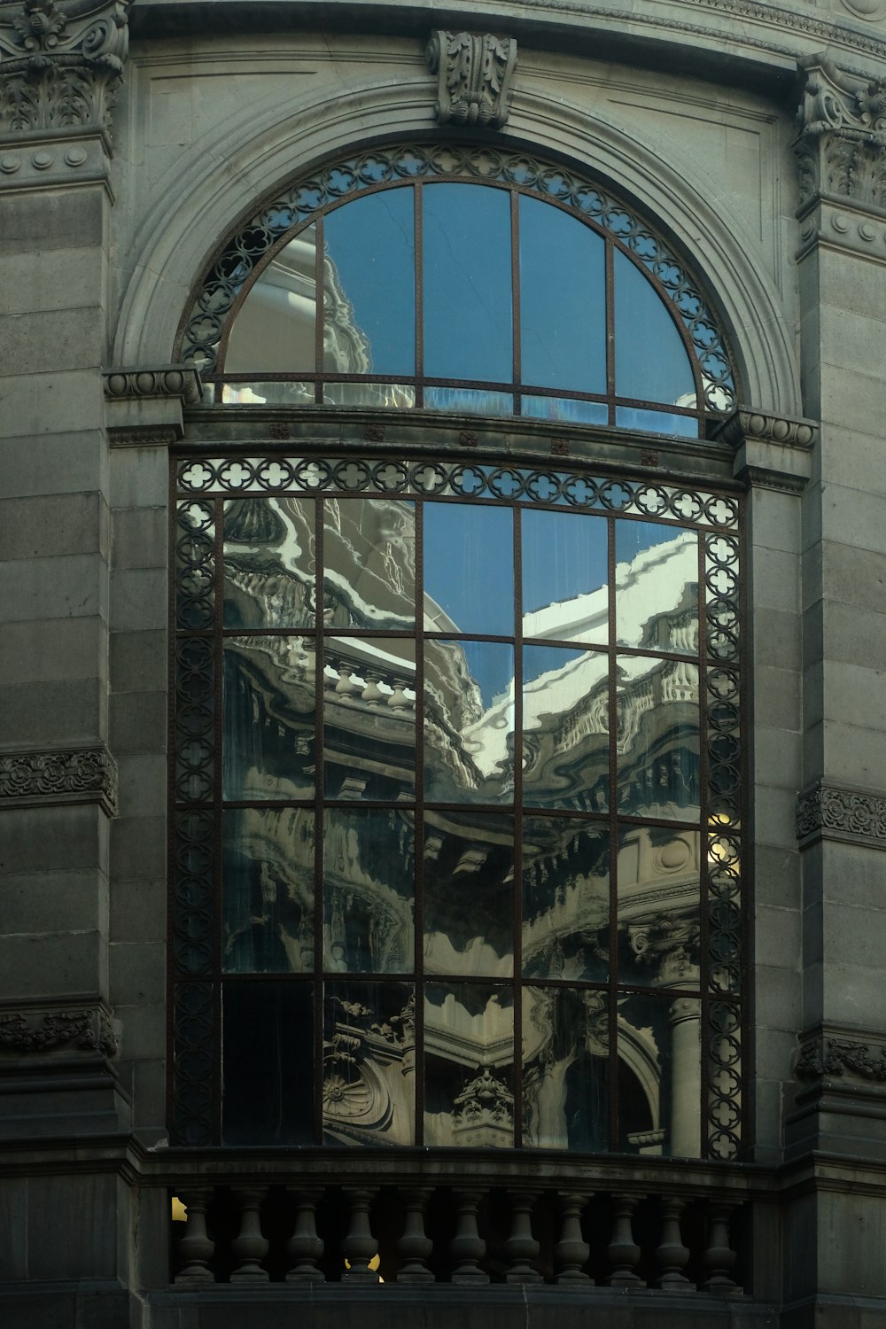 a reflection of a building in a window