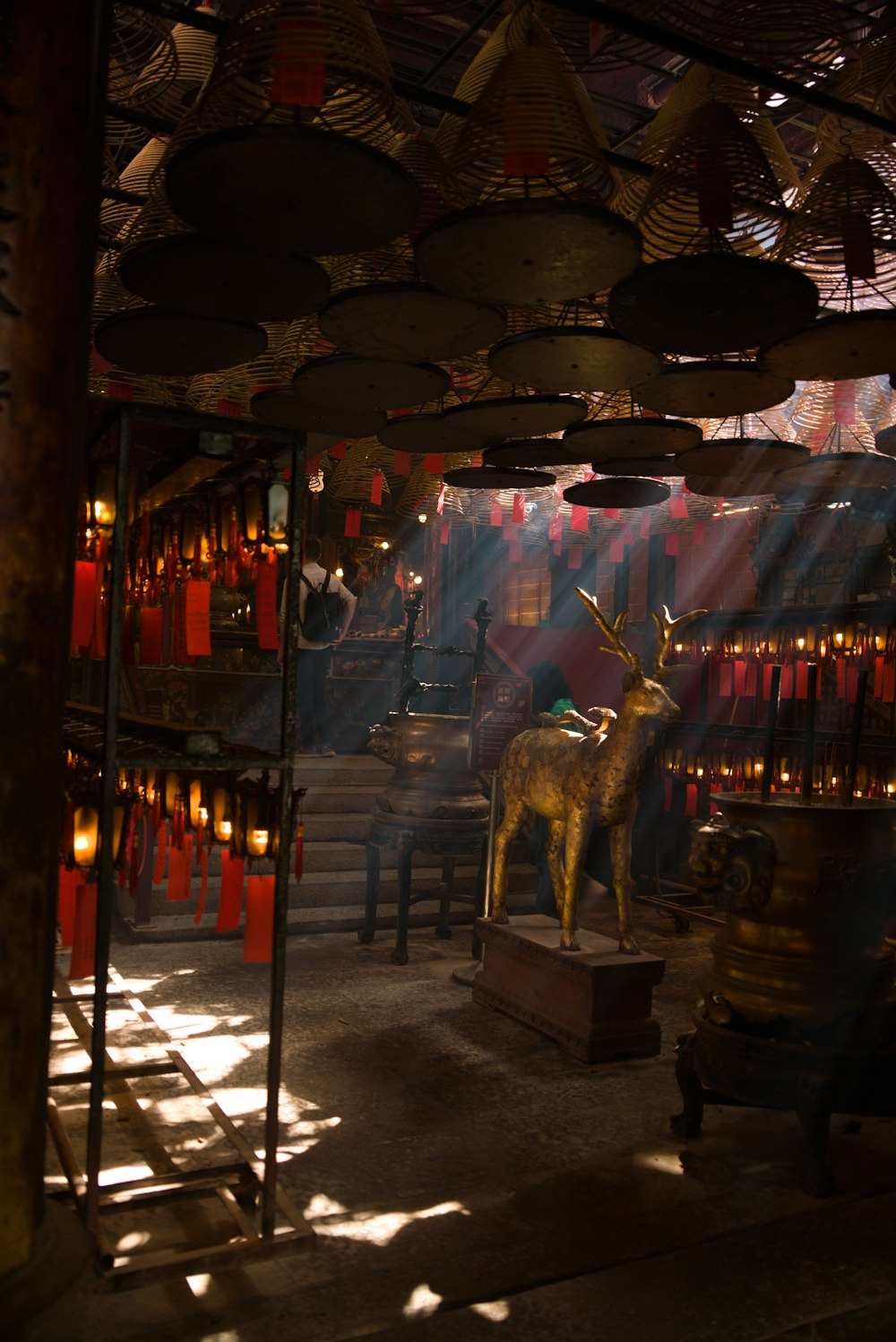 a statue of a deer in a room with many lights