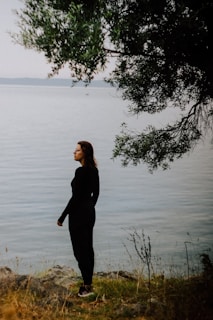 A person in quiet reflection outdoors, symbolizing personal growth and inner journey inspired by tarot therapy.