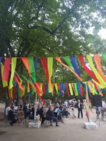 An outdoor school event where students perform string pieces, surrounded by an engaged audience.