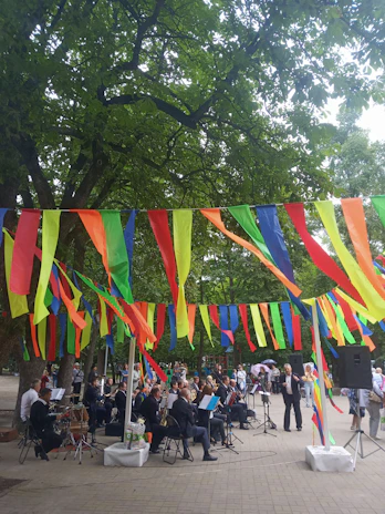 A lively orchestra performing outdoors in Três Coroas with smiling musicians.