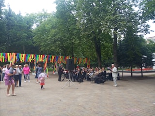 Children and adults enjoying a lively outdoor music event in the city park.
