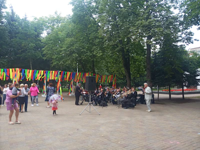 A group of friends sharing music with stylish neckbands during a park hangout.