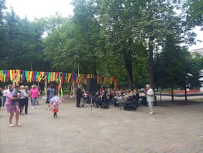 A community event in a park with families enjoying music and food.